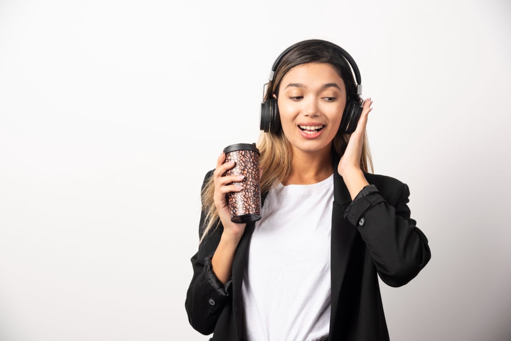 woman using headphones - Uberduck Alternatives