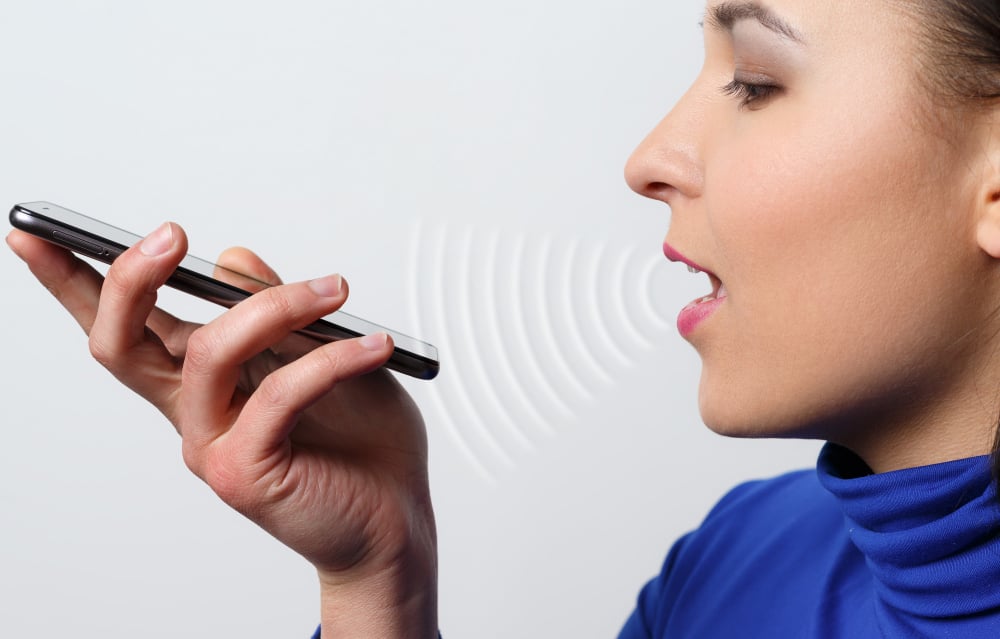 woman using mobile voice to text tool - 15 AI