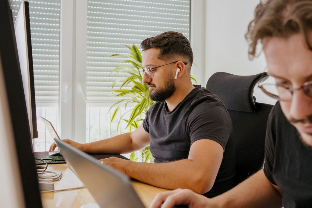 man using a laptop - Uberduck Alternatives