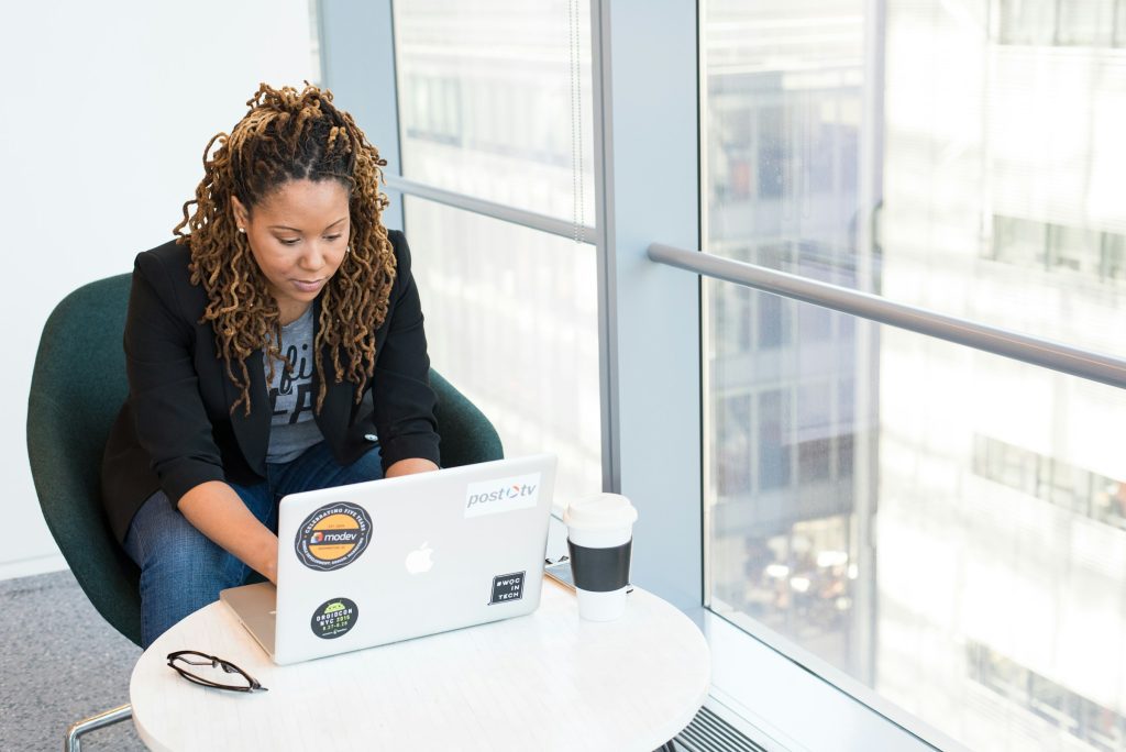 woman using a laptop - Play HT