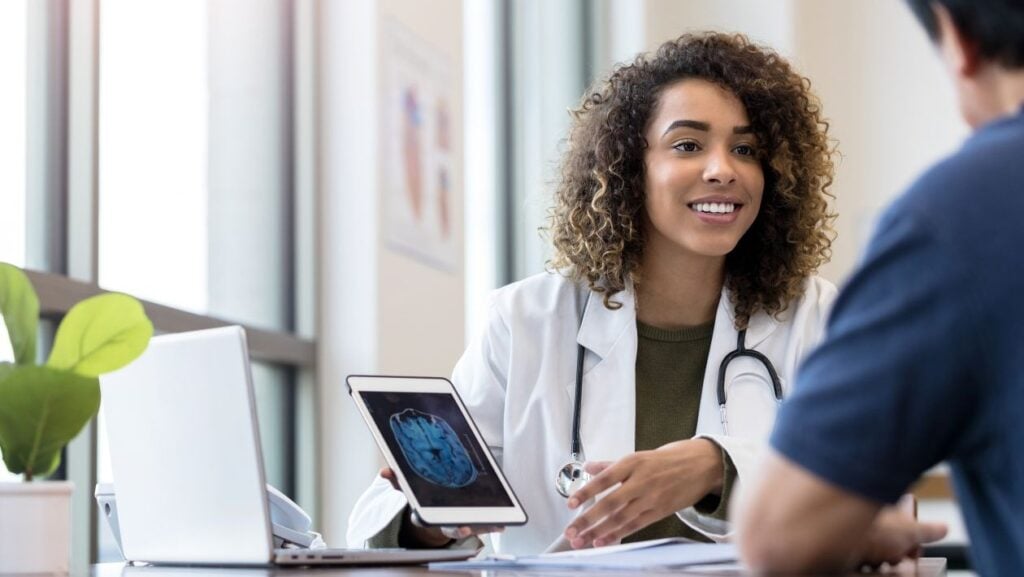 Woman Doctor Using Tablet - Conversational AI in Healthcare