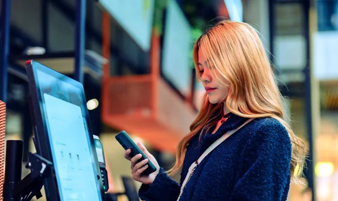 woman using mobile - Conversational AI in Retail