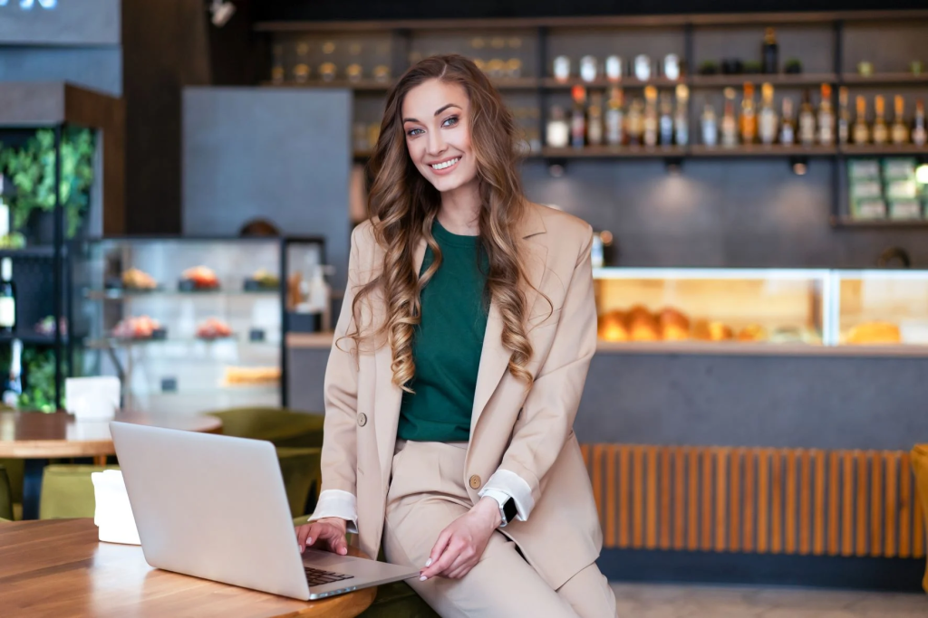 woman in a suit sitting on a table - Voice Ordering for Restaurants
