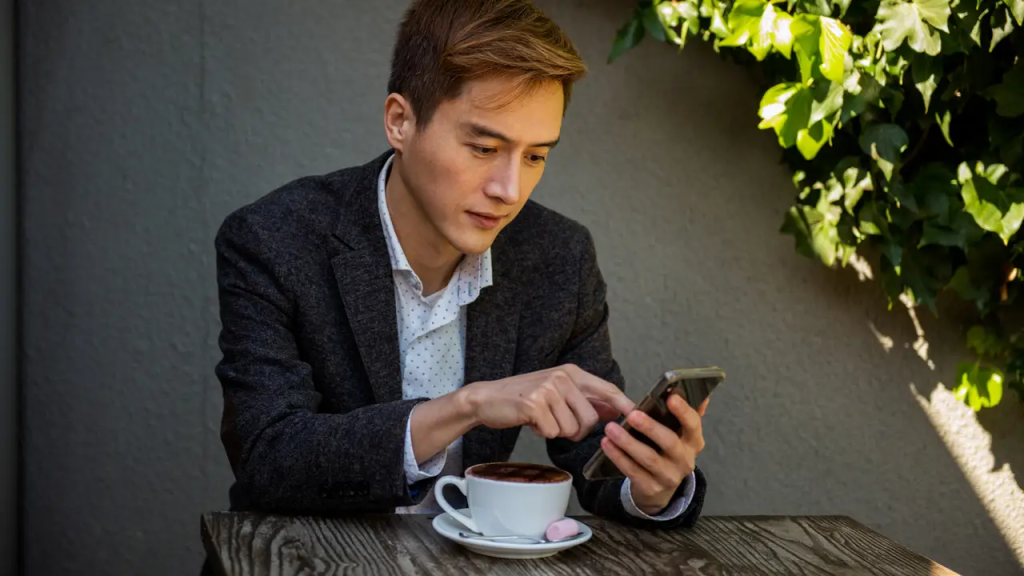 man using his phone - Conversational AI in Banking
