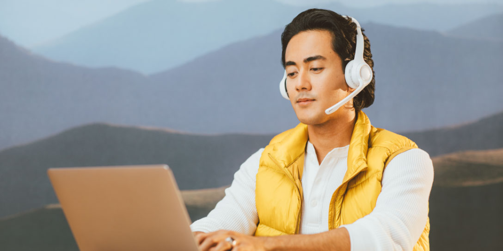 man using headphones - Voice AI Companies