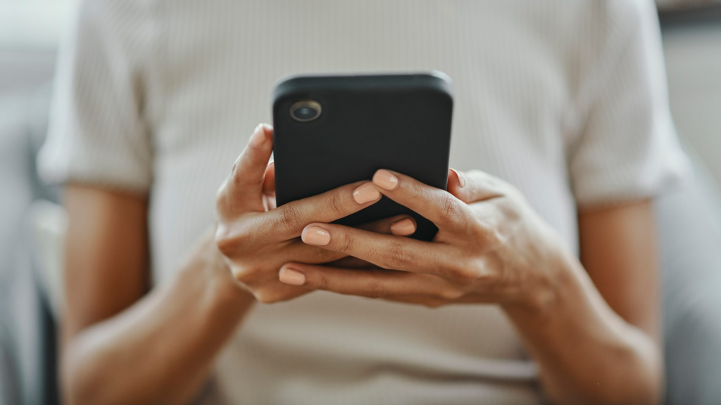 woman holding a phone - TikTok Text to Speech Not Working