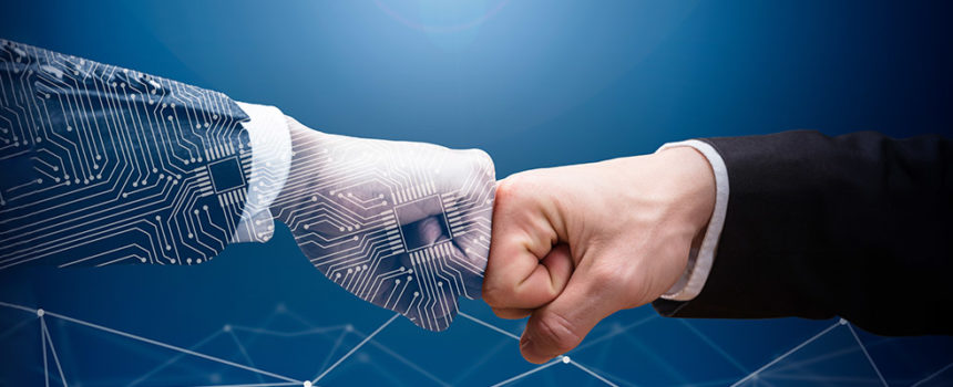 ai and human hand giving fist bumps - How to Use AI in Sales
