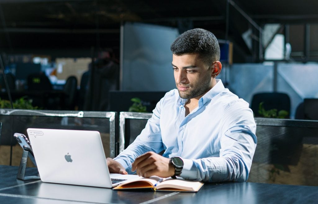 man on a laptop - Conversational AI for Finance