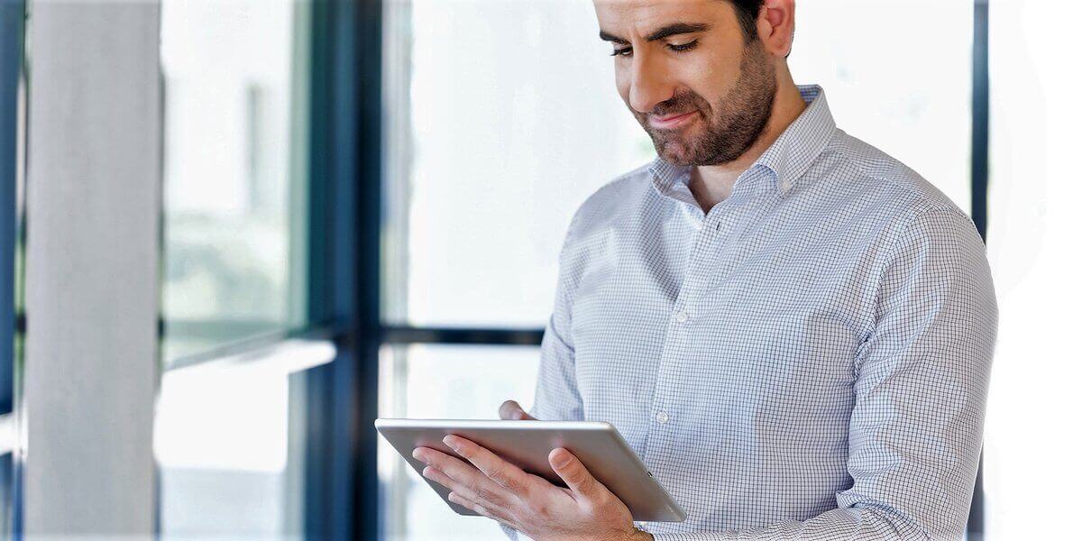 man using ipad - How to Enable Text to Speech on iPad