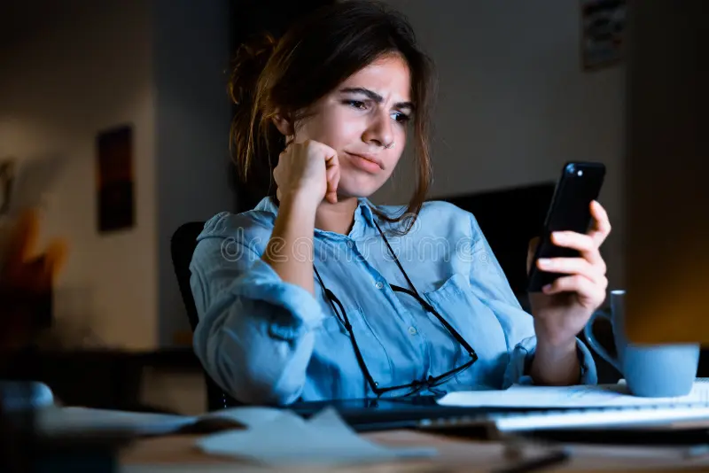 woman looking at her phone - How to Text to Speech on Android
