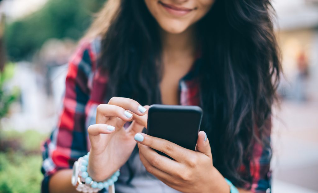 woman using her phone - How to Text to Speech on Android