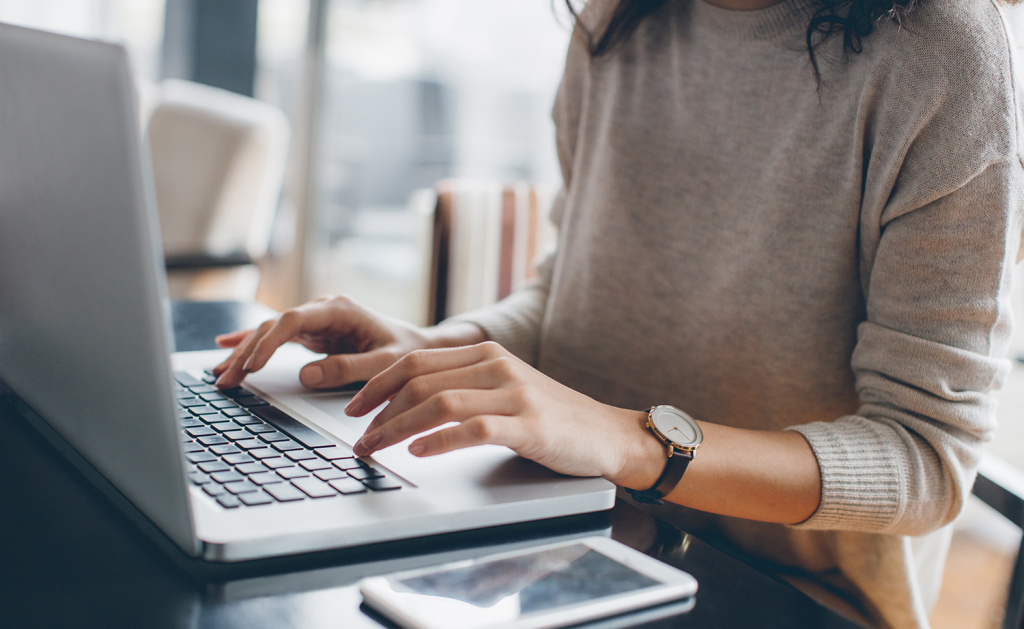 woman typing on a laptop - How to Do Text to Speech on Google Slides