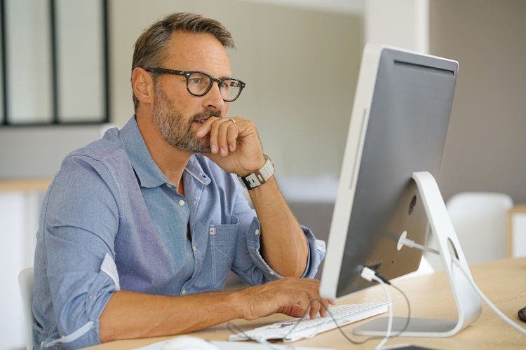 man using a computer - How to Do Text to Speech on Google Slides