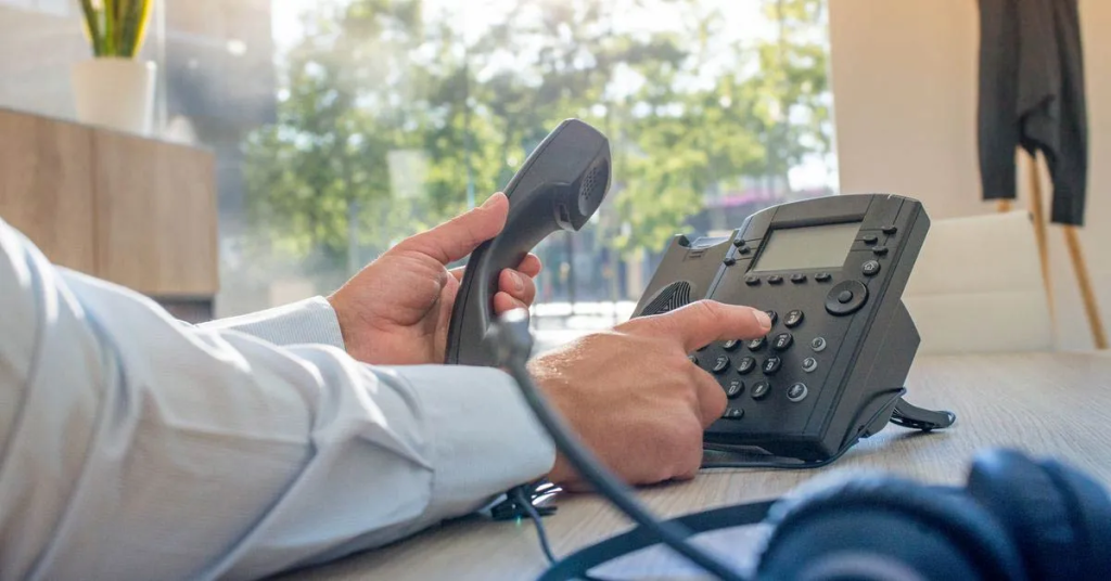 man dialing on a phone - Upgrade Phone System
