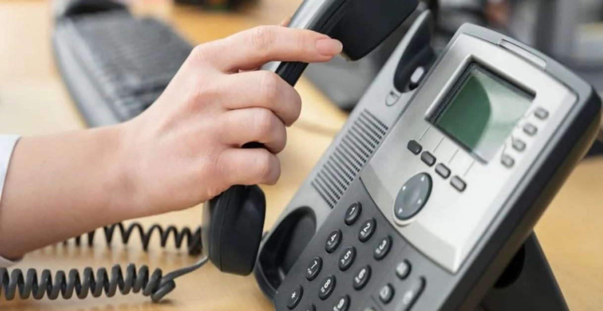 person dialing on phone - VoIP Phone Type