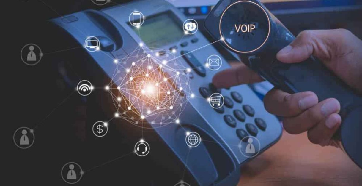 person dailing on telephone - Benefits of VoIP