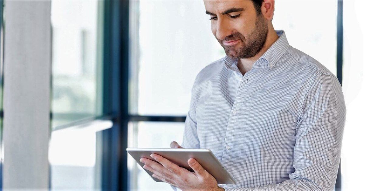 man using ipad - How to Enable Text to Speech on iPad