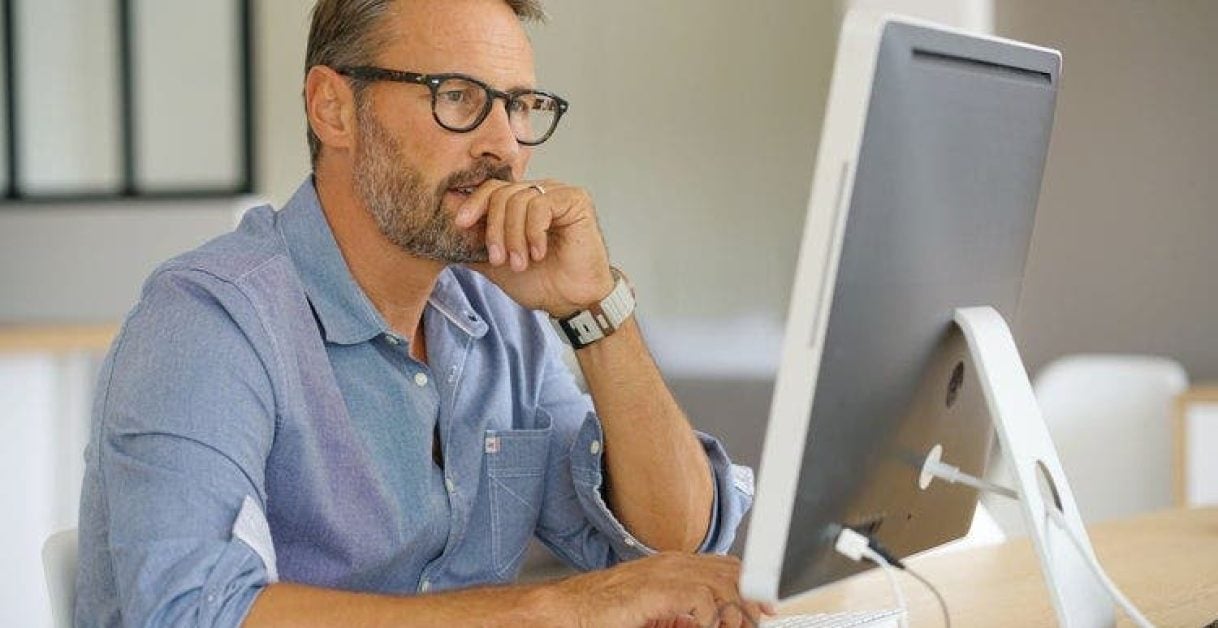 man using a computer - How to Do Text to Speech on Google Slides